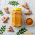 Adding authentic Afghan turmeric powder to a traditional curry dish for natural color and rich flavor.